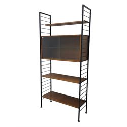 Staples Ladderax - mid-20th century teak and metal framed modular wall unit, fitted with central cupboard, the sliding glazed doors enclosing single shelf, flanked by three adjustable shelves 