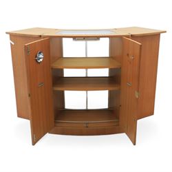 Turnbridge of London - Mid 20th century teak cocktail cabinet, with fold out top extending to 160cm, with twin doors revealing a shelved interior, the back with sliding glazed doors, raised on a recessed plinth base with castors