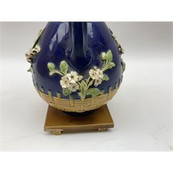 Minton majolica vase, the squat body with twin handles, with part osier moulding and applied Spring flowers against a cobalt blue ground, upon integral square base, impressed beneath Minton 1316, H16.5cm