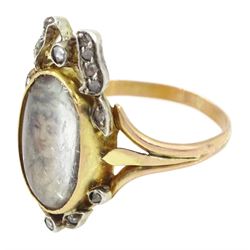 19th century gold and silver diamond portrait ring, set with an oval miniature of a woman on ivory, under a glazed panel, with rose cut diamond bow and floral sprigs below, to trifuricated shoulders. This lot has been registered for sale under Section 10 of the APHA Ivory Act