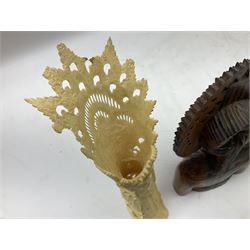 Hardwood bust of an Indoniesian Goddess, carved wearing a pierced headdress, from Klungkung, Bali, H20cm, together with a pair of bone carvings of deity figures, and a carved wood Netsuke in the form of a Chinese dragon