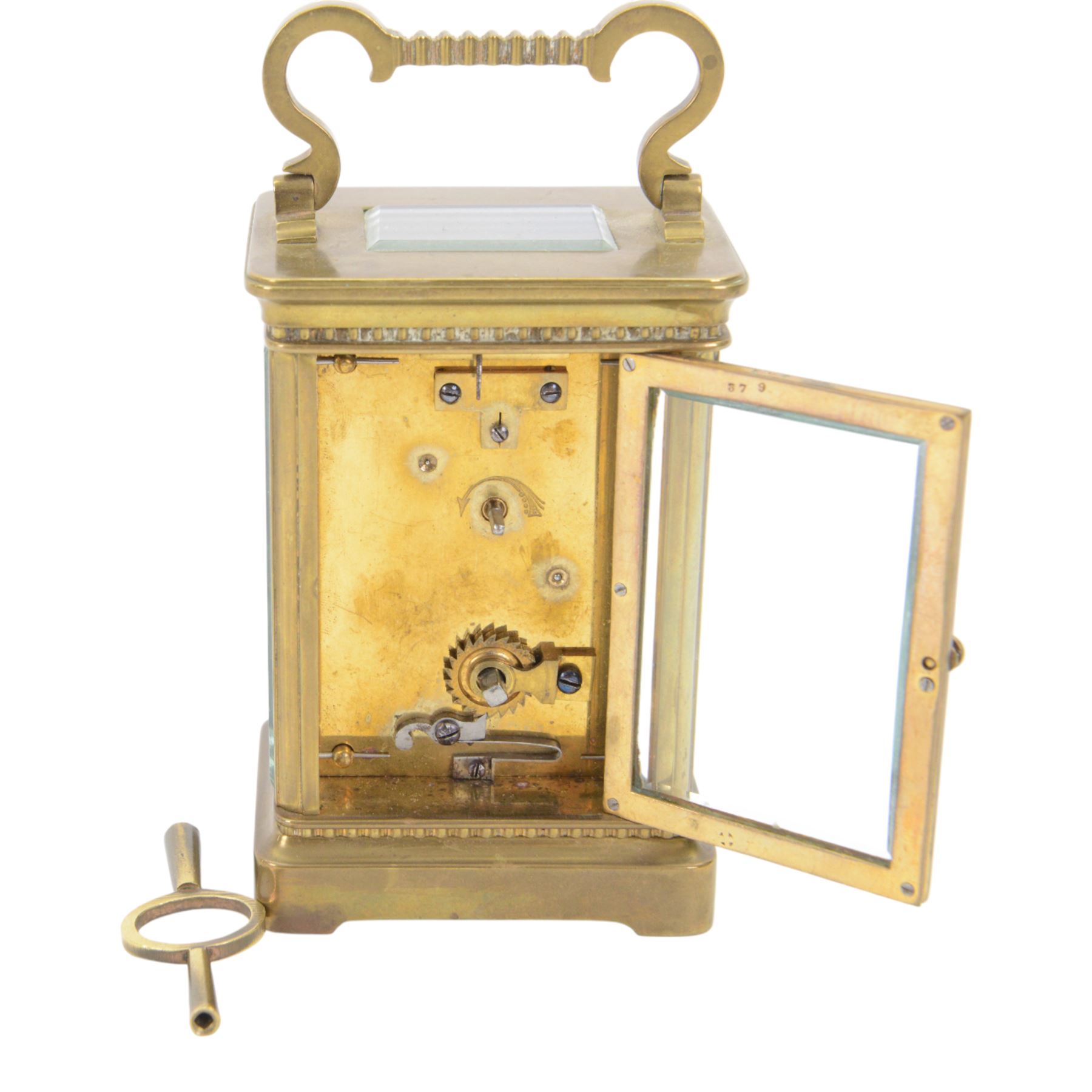 French-Edwardian 8-day timepiece carriage clock with a cylinder platform escapement, anglaise style brass case with four glass panels, dial with a polished gilt mask and foliate decoration, white enamel chapter with Arabic numerals and steel spade hands, . With Key. 