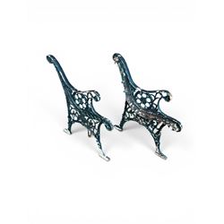 Pair of ornate painted cast iron bench ends, painted in green