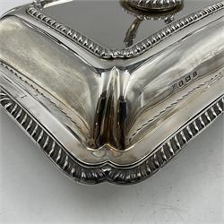 Early 20th century silver entree dish and cover, of rectangular form with shaped corners and oblique gadrooned borders to base and cover, the cover with loop 'bamboo' handle, hallmarked Thomas Bradbury & Sons Ltd, Sheffield 1930, including handle H10.5cm L24.5cm