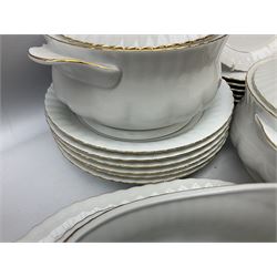 Chodziez Polish dinner wares decorated in white and gilt to include lidded twin handled tureens, bowls, plates etc