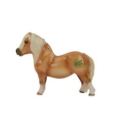 Three Beswick Horses, comprising skewbald Pinto Pony no 1373, Palomino horse and Palomino shetland