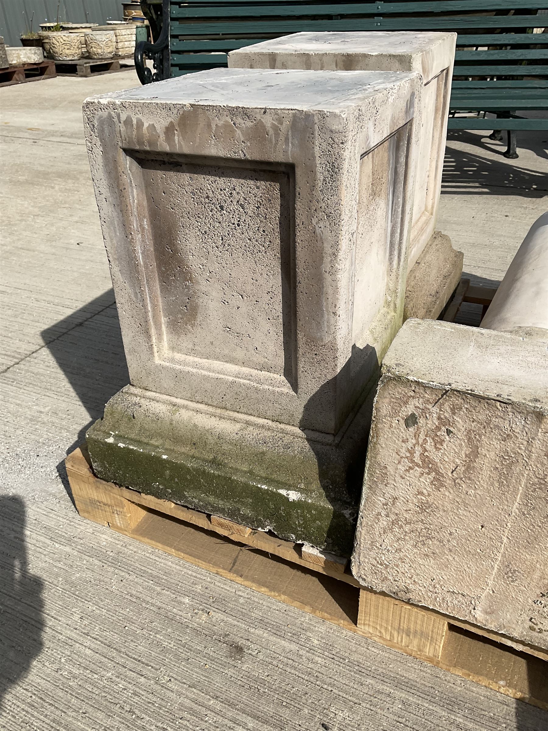 Set of four cast stone architectural columns, tapering form, on square plinth bases