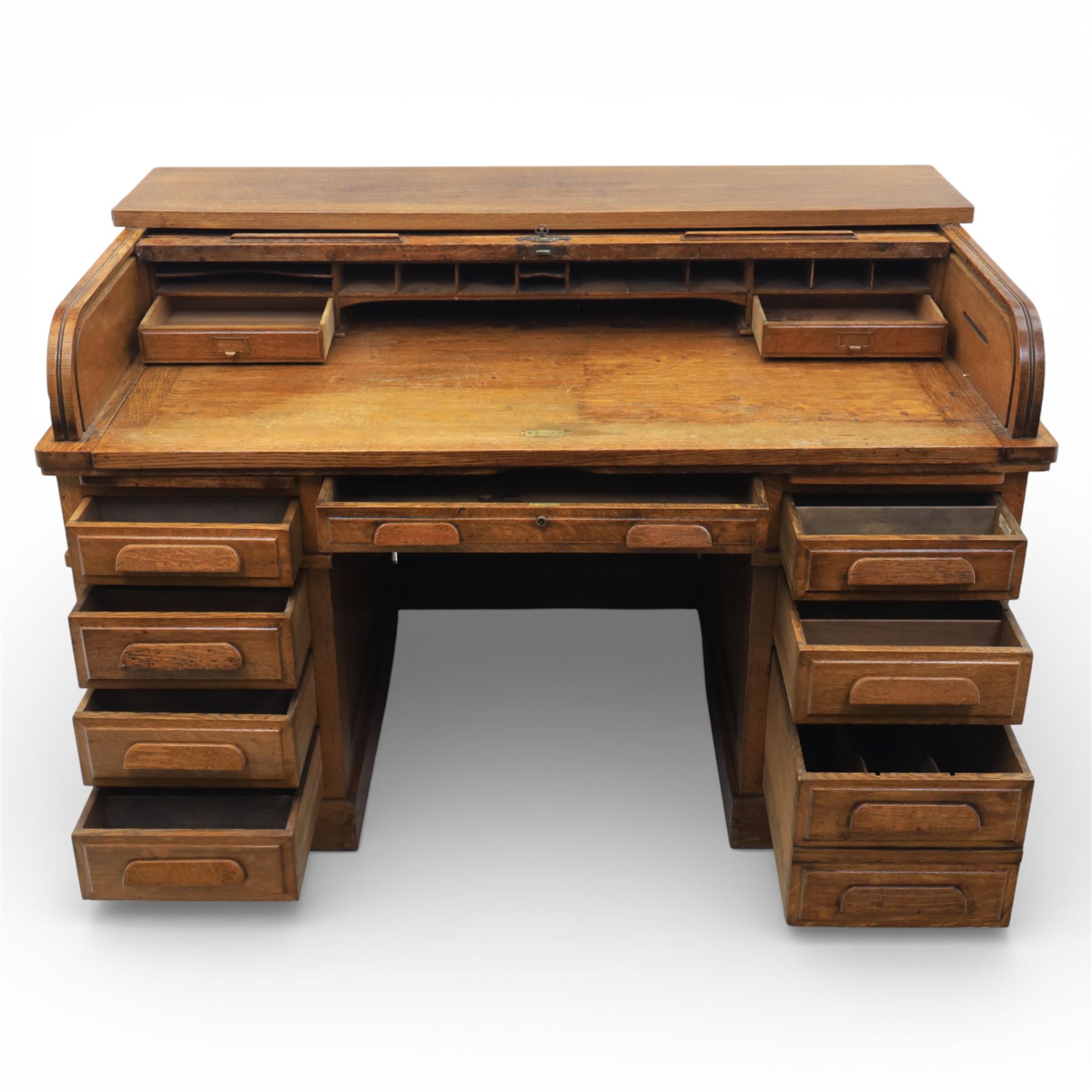 Globe Wernicke - Oak roll top desk, fitted with nine drawers, oak tambour roll top revealing a fitted interior, with single frieze drawer, flanked by four drawers to each pedestal, on a plinth base