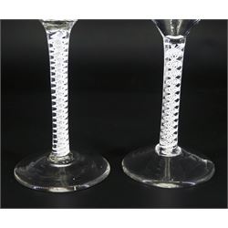 Two 18th century drinking glasses, with ogee part fluted bowls upon double series opaque twist stems and conical feet, each approximately H15cm