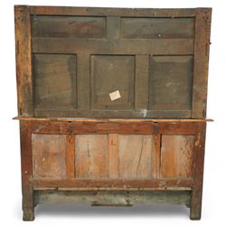An early 20th-century Jacobean revival style carved oak Court Cupboard, tier-form of 17th-century design, rectangular form with carved back with geometric motifs and arches, projecting top section over twin baluster columns connecting the lower tier above a carved panelled front and panelled cupboard door with profusely carved lozenges and lunettes, above two base drawers, raised on block feet 