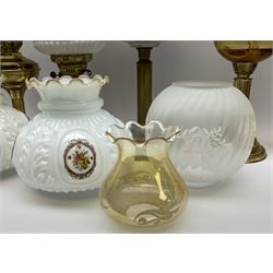 pink opaline glass and metal oil lamp together a pair of oil lamps with match opaline glass shades with printed floral decoration, a ceramic oil lamp with crazing and floral design, with further five oil lamps and one mining lamp. 