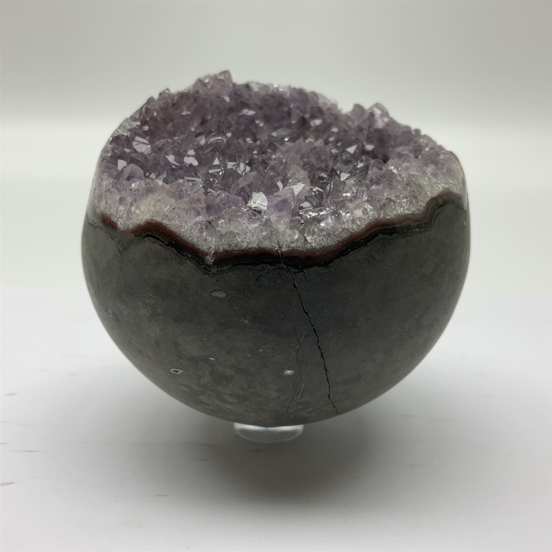 Pair of amethyst geode spheres, with purple crystalline internal formations, D9cm