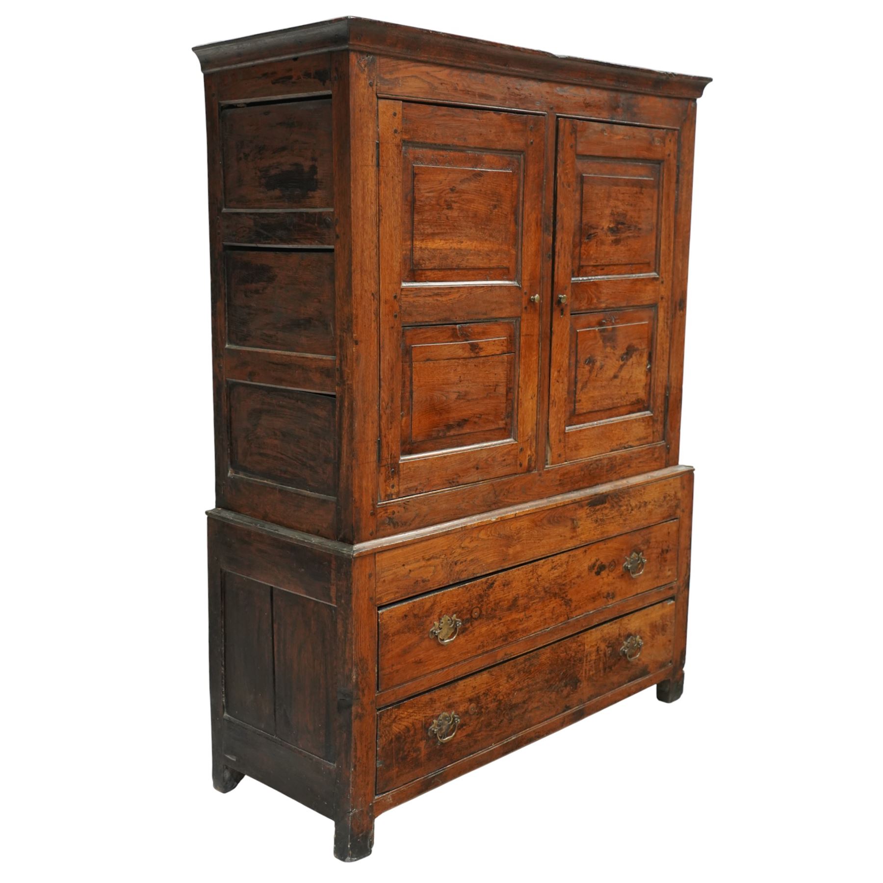 Georgian rustic oak housekeeper’s cupboard, moulded cornice above a pair of fielded panel cupboard doors enclosing a boarded interior with central divider and hanging hooks, the base fitted with two long drawers with brass swan neck handles, raised on stile supports