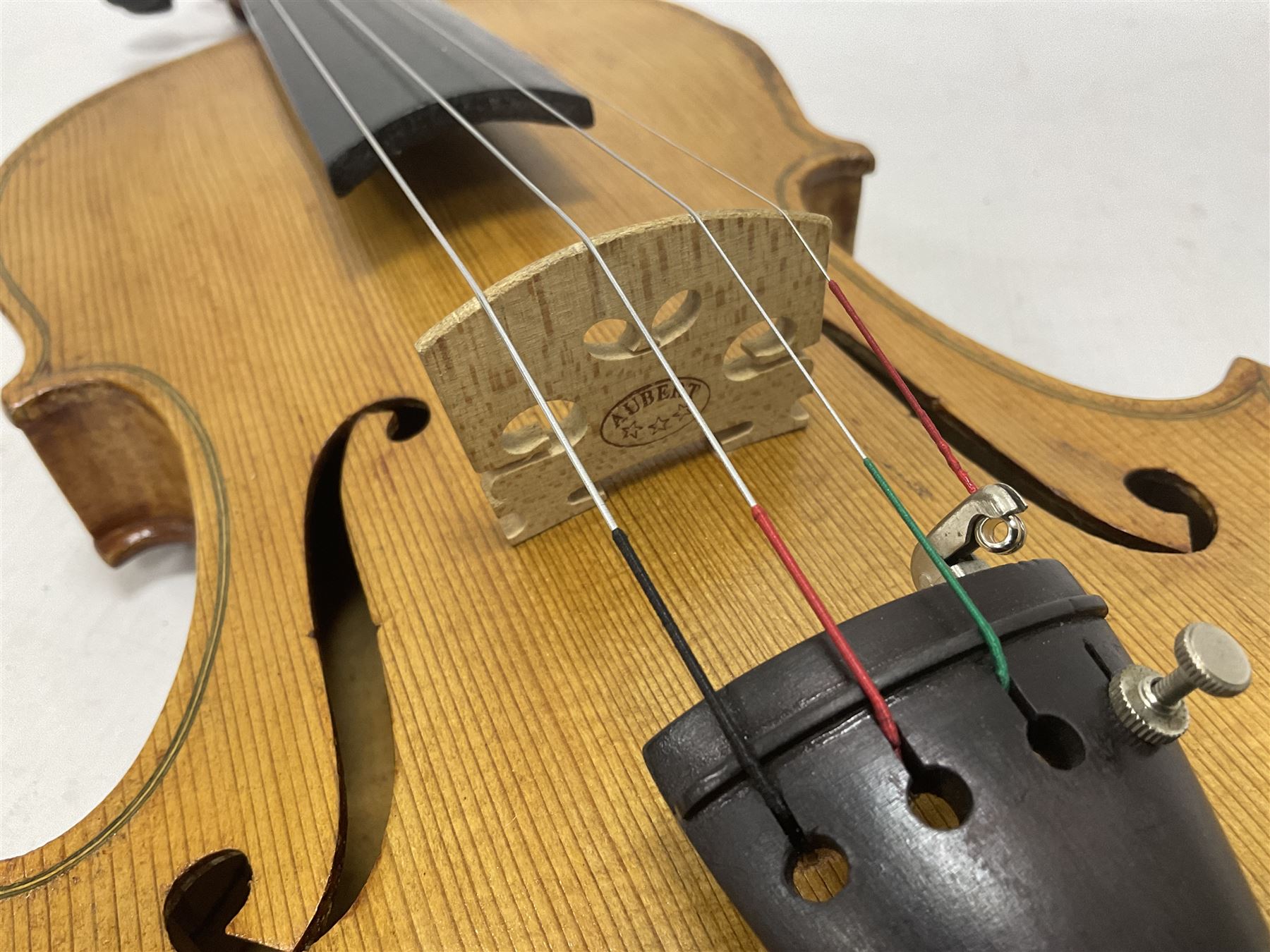 Copy of a full size Stradivarius violin, with an ebonised fingerboard, tailpiece and tuning pegs Length 60cm