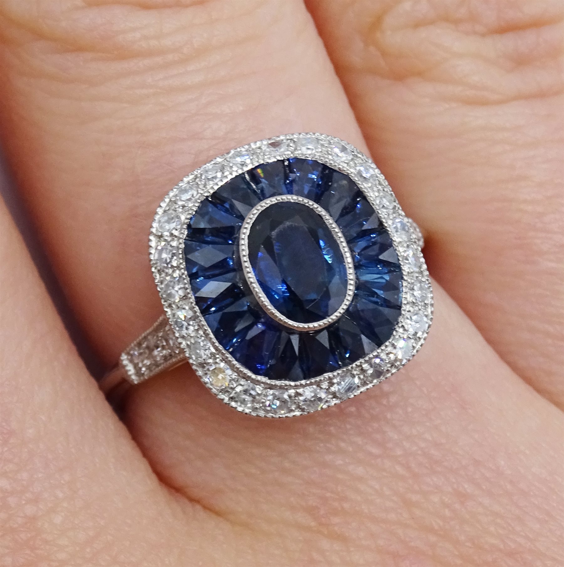 Platinum sapphire and diamond ring, the central oval sapphire