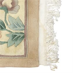 Chinese wool rug, beige ground decorated with peonies, flowering branches and butterflies, centred by a shou symbol within key pattern surround, cream border with floral sprays and double happiness motifs, cotton fringe ends