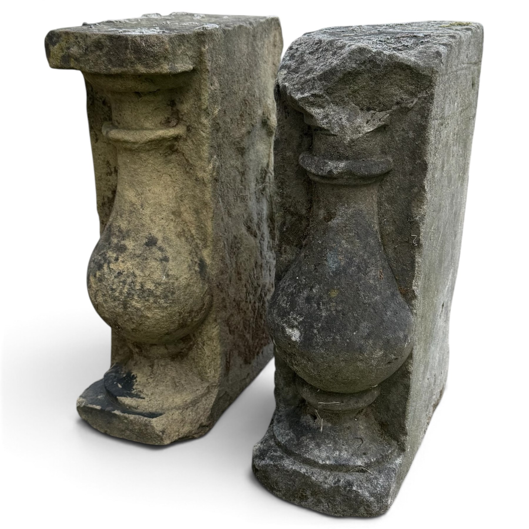 Pair of George III weathered carved sandstone architectural corbels, each with a projecting moulded capital above a half-canted baluster, waisted socle and stepped base
