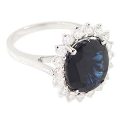 18ct white gold sapphire and diamond cluster ring, single oval cut sapphire of approx 4.30 carat, sounded by eighteen round brilliant cut diamonds, stamped, total diamond weight approx 0.75 carat