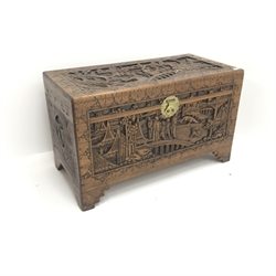  Early 20th century camphor wood chest, hinged lid with clasp and stay, heavily carved depicting town scene, shaped bracket supports, W102cm, H61cm, D51cm  