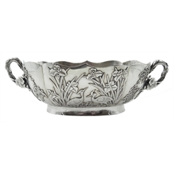  Chinese export silver bowl in the Japanese style circa 1900, decorated in relief with iris, chrysanthemum, egrets, humming birds and prunus blossom handles, beaten interior, signature panels and letters DETU  