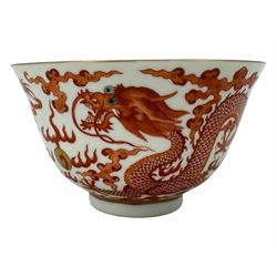 Chinese porcelain iron red tea bowl, the exterior painted with two five claw dragons chasing the flaming pearl, amidst clouds, red Quinlong seal mark beneath, D10.5cm x H6.5cm