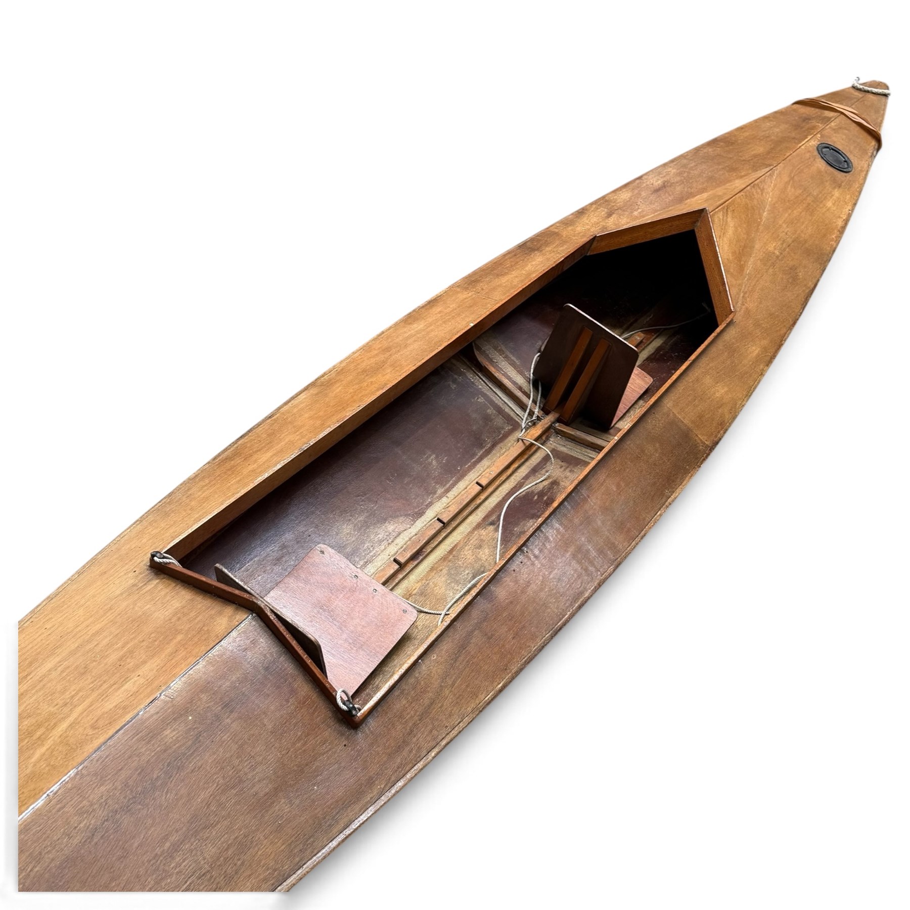 Mid-20th century varnished marine plywood two-person touring kayak, the decked hull with pointed bow and stern, two circular Holt-Allen access hatches and central open cockpit fitted with seats
