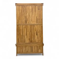 Modern light oak double wardrobe, with twin panelled doors enclosing hanging rail and full-height interior, above a deep lower drawer with recessed handle, shaped stiles