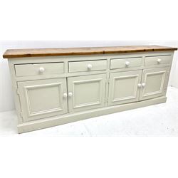 Large pine and painted side board, four drawers above four cupboards, plinth base