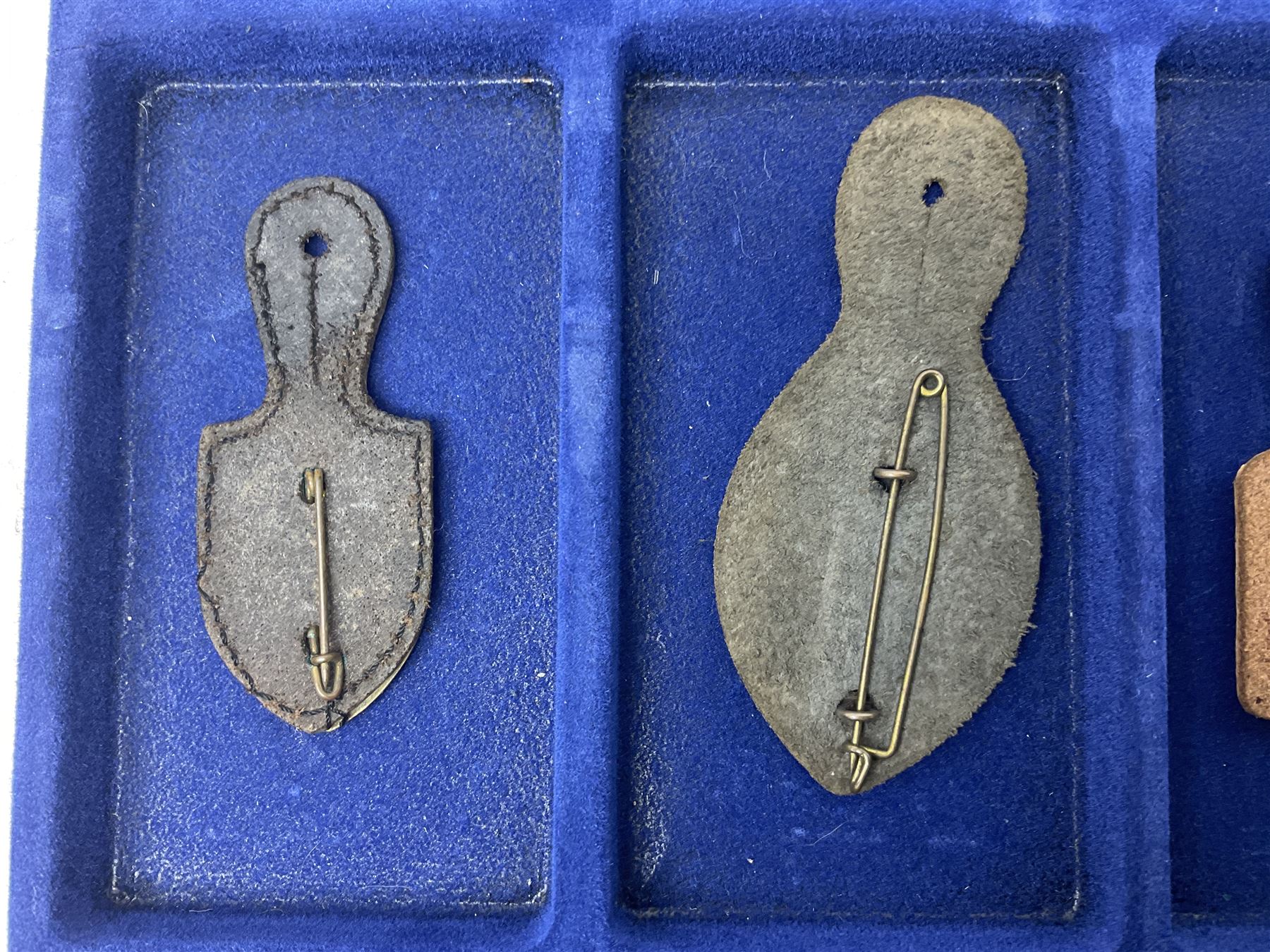 Twelve French military metal badges mounted on leather fobs including Legion, Artillery, Parachutist, Air Force, Infantry etc