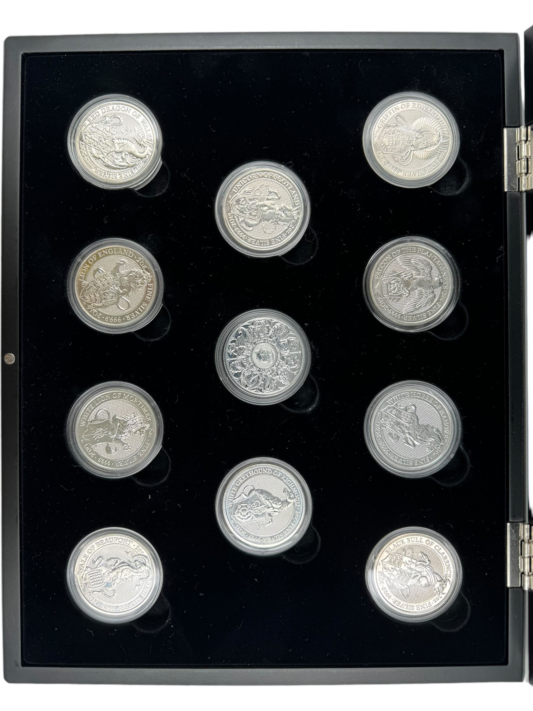 Eleven Queen Elizabeth II 'Queen's Beasts' two ounce fine silver coins, including 2016 'Lion of England', 2017 'Griffin of Edward', 2018 'Black Bull of Clarence' etc, housed in a display case