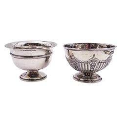 Silver sugar bowl, probably Edwardian, of circular form with repousse part fluting, upon circular stepped foot, hallmarks worn and indistinct, probably Sheffield 1901, H8cm D11.5cm, together with a later mid 20th century example, of plain footed circular form, hallmarked Robert Pringle & Sons, London 1950, H7.5cm D11cm, approximate total weight 6.13 ozt (190.7 grams)