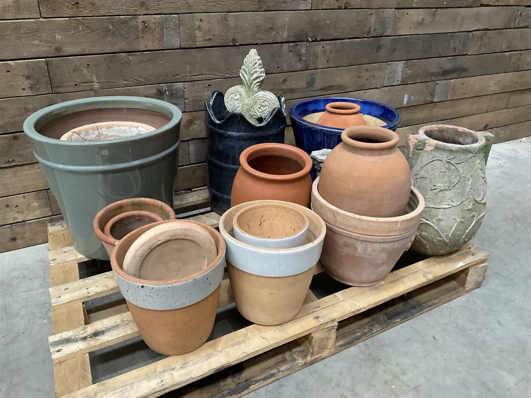 A quantity of various terracotta and glazed planters