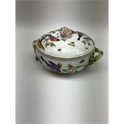 Continental Meissen style tureen and cover, with osier moulded borders, decorated with birds and insects, twin green branch handles and the cover surmounted with a floral finial, spurious mark beneath, H12cm  