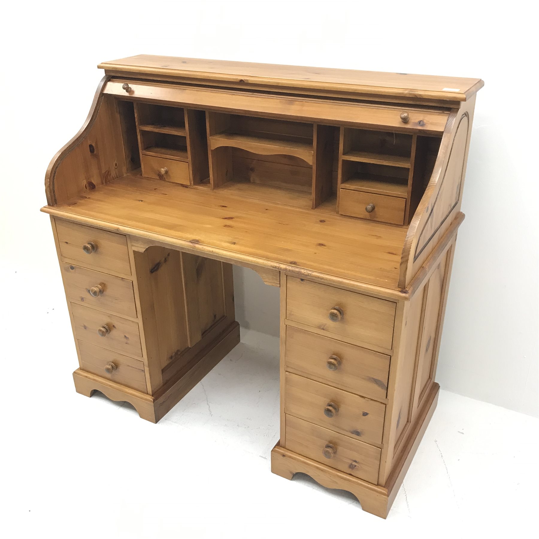 Solid pine twin pedestal shaped tambour roll top desk, fitted interior, eight drawers, shaped plinth base, W117cm, H111cm, D55cm