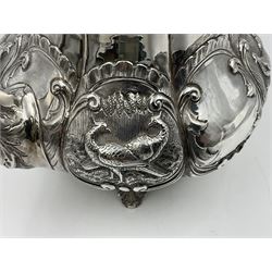 Victorian silver three piece tea service, comprising teapot, twin handled open sucrier, and milk jug, each of bellied form with acanthus capped scroll handles, the sides embossed with alternating scroll edged vacant panels and panels containing a pair of birds, upon four palmette feet, the teapot with ivory insulators to handle, and bird finial to the hinged domed cover, hallmarked William Hunter & Son, London 1861, teapot H19cm, including handles sucrier H13.5cm, including handle milk jug H12cm

This item has been registered for sale under Section 10 of the APHA Ivory Act