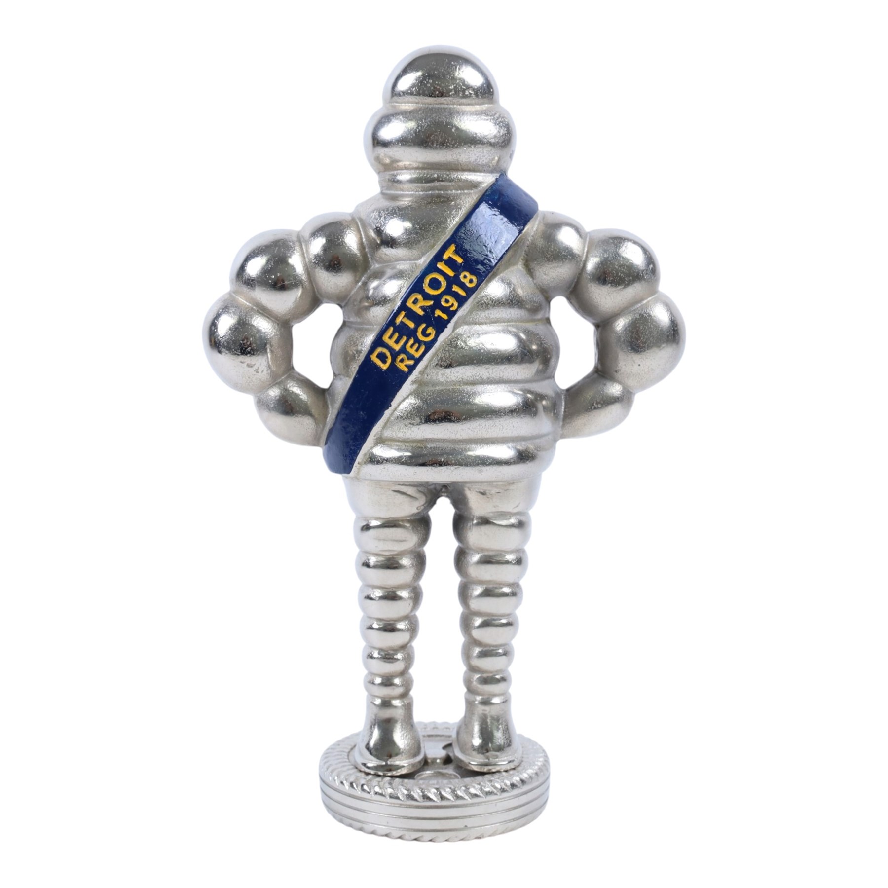 Metal hollow-cast figure, modelled as a Michelin Man stood upon a tire, H26.5cm