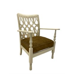 Early 20th century low painted open armchair, fretwork applied back, upholstered seat cushion, on turned supports