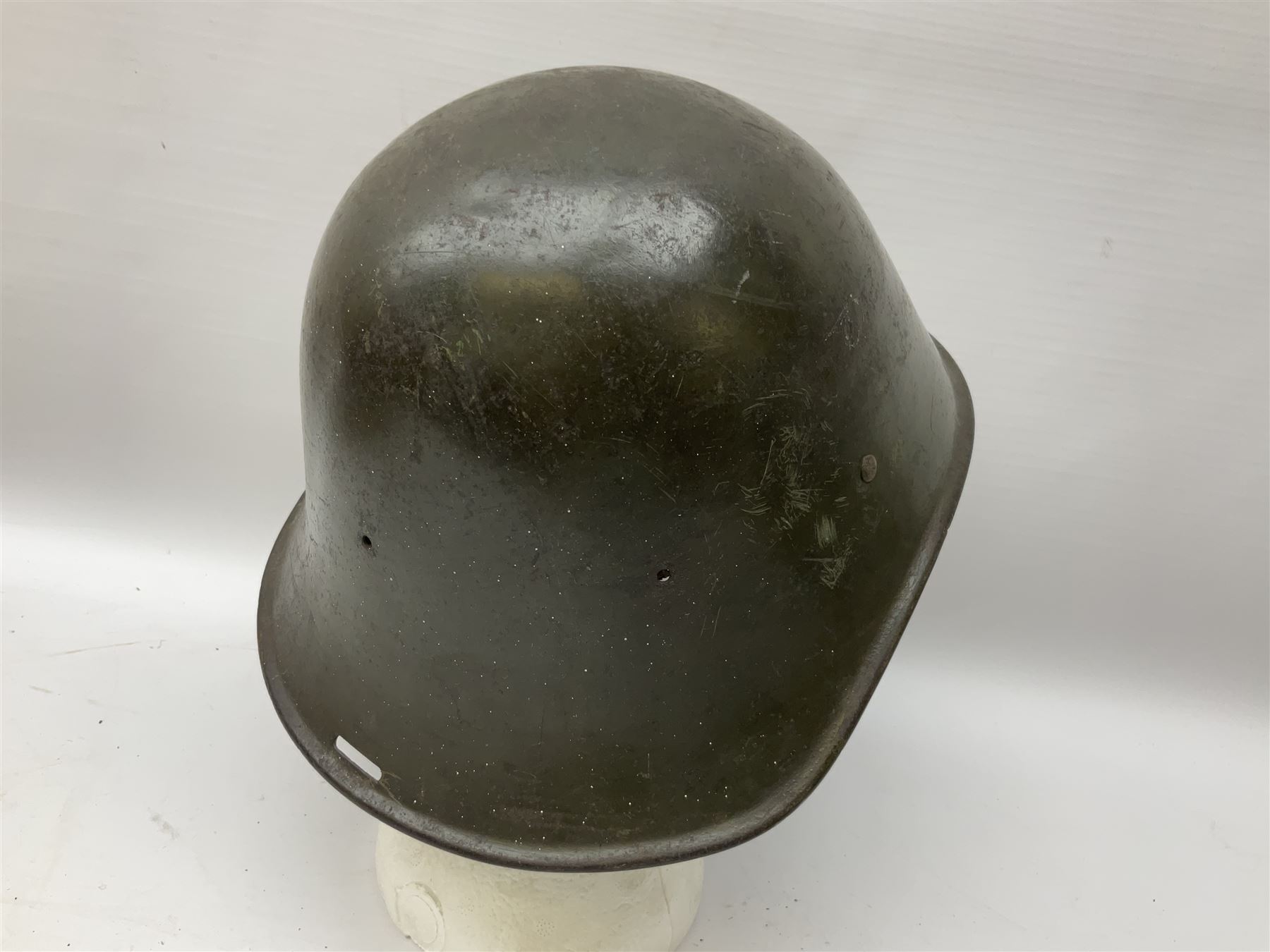 WW2 French M-26 Adrian Pattern Steel Helmet, original olive drab paint finish; flaming grenade badge to the front signifying issue to an Infantry regiment; original leather liner and leather chinstrap; and WW2 Dutch steel helmet with liner and chin strap (2)
