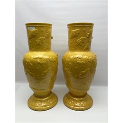 Pair of 20th century large floor standing vases with decorated in relief on yellow ground, depicting a dragon in a cloudy sky, with crackle glazing, H64cm