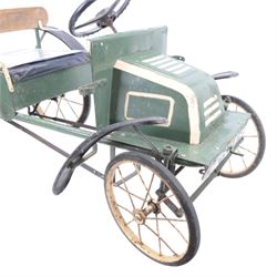 Triang child's pedal car in the style of a vintage automotive, likely a De Dion Bouton or an early Renault, painted in dark green with pale yellow details, H52cm