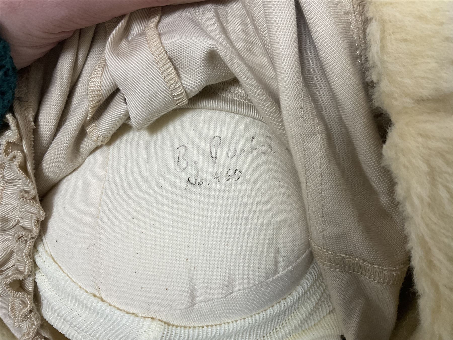 Two Zapf Creation limited edition designer collection dolls, by Brigette Paetsch, the first example with faux suede jacket, red jumper and denim skirt, no. 460, the second example 'Linda' in white dress with teddy bear accessory, no. 785, each signed B Paetsch, tallest L60cm