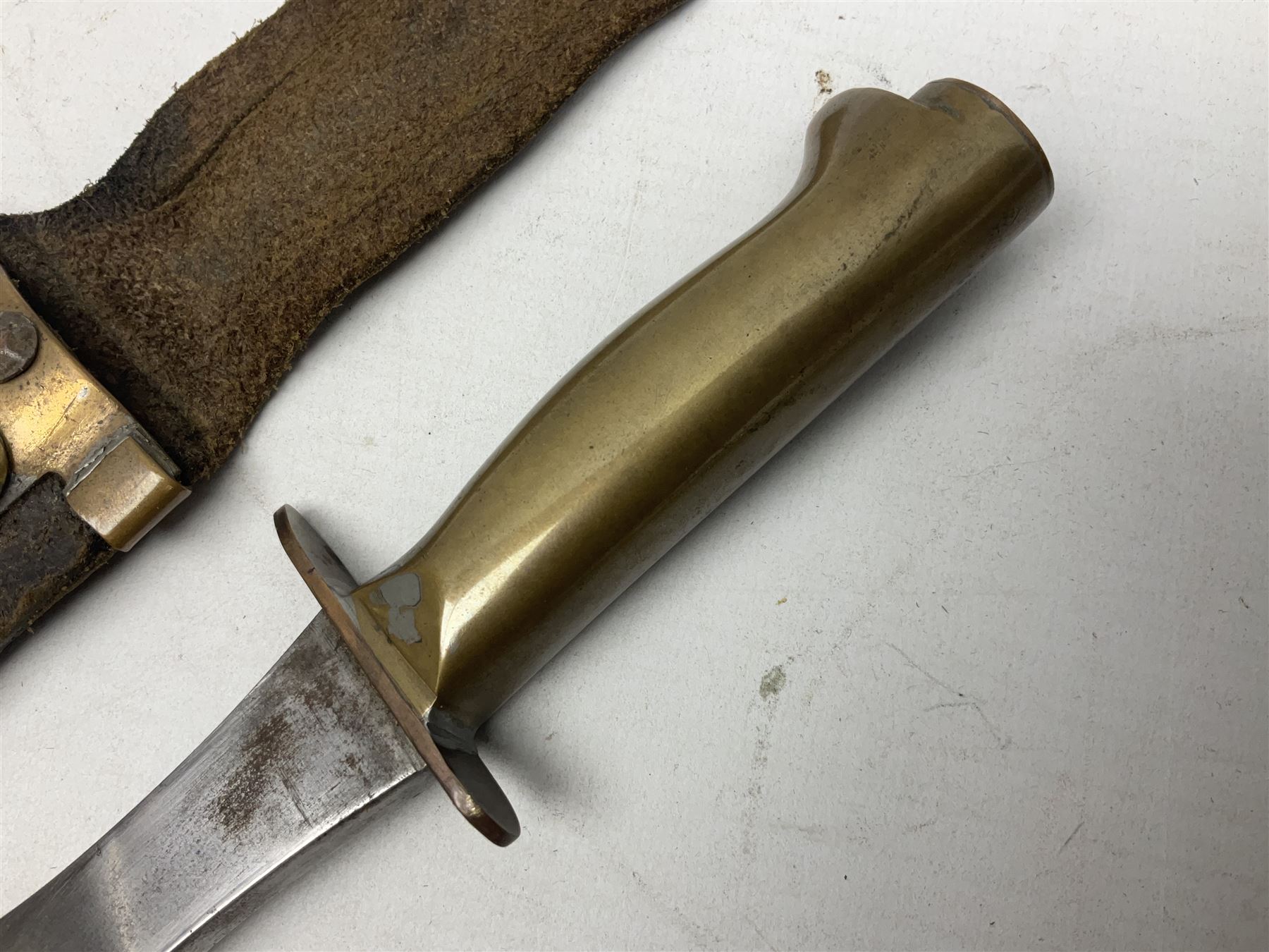 Scratch-built fighting/throwing knife, probably trench art, with 18cm steel spear type blade, plain cross-piece and French Lebel Rifle bayonet grip; in bras mounted studded leather sheath with belt hanger L29.5cm overall