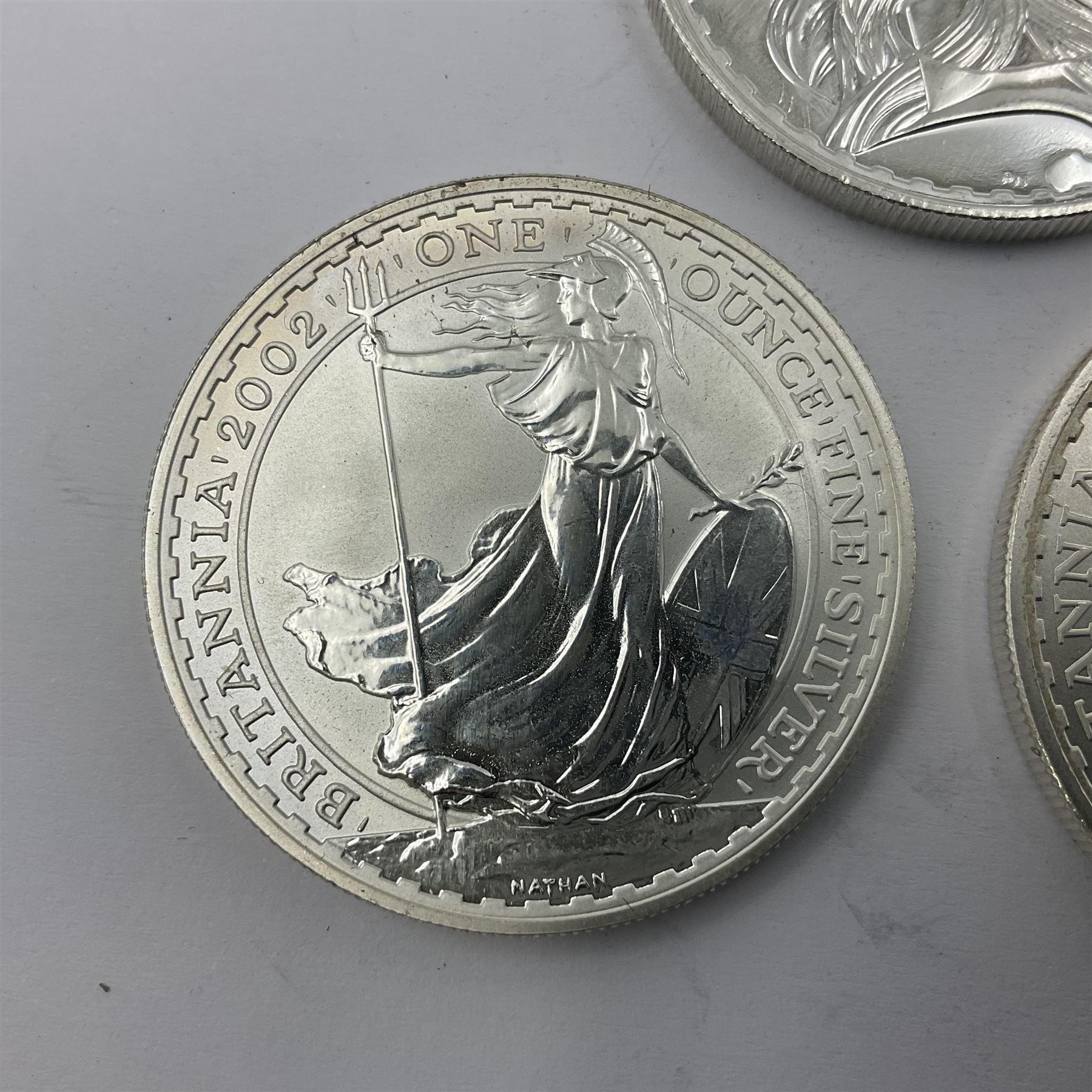 Five Queen Elizabeth II United Kingdom one ounce fine silver Britannia two pound coins dated 2002, 2003, 2004, 2005 and 2006