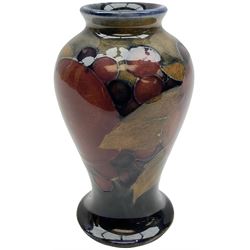 Moorcroft vase of baluster form decorated in the 'Pomegranate' pattern upon dark blue ground with impressed mark, H10cm