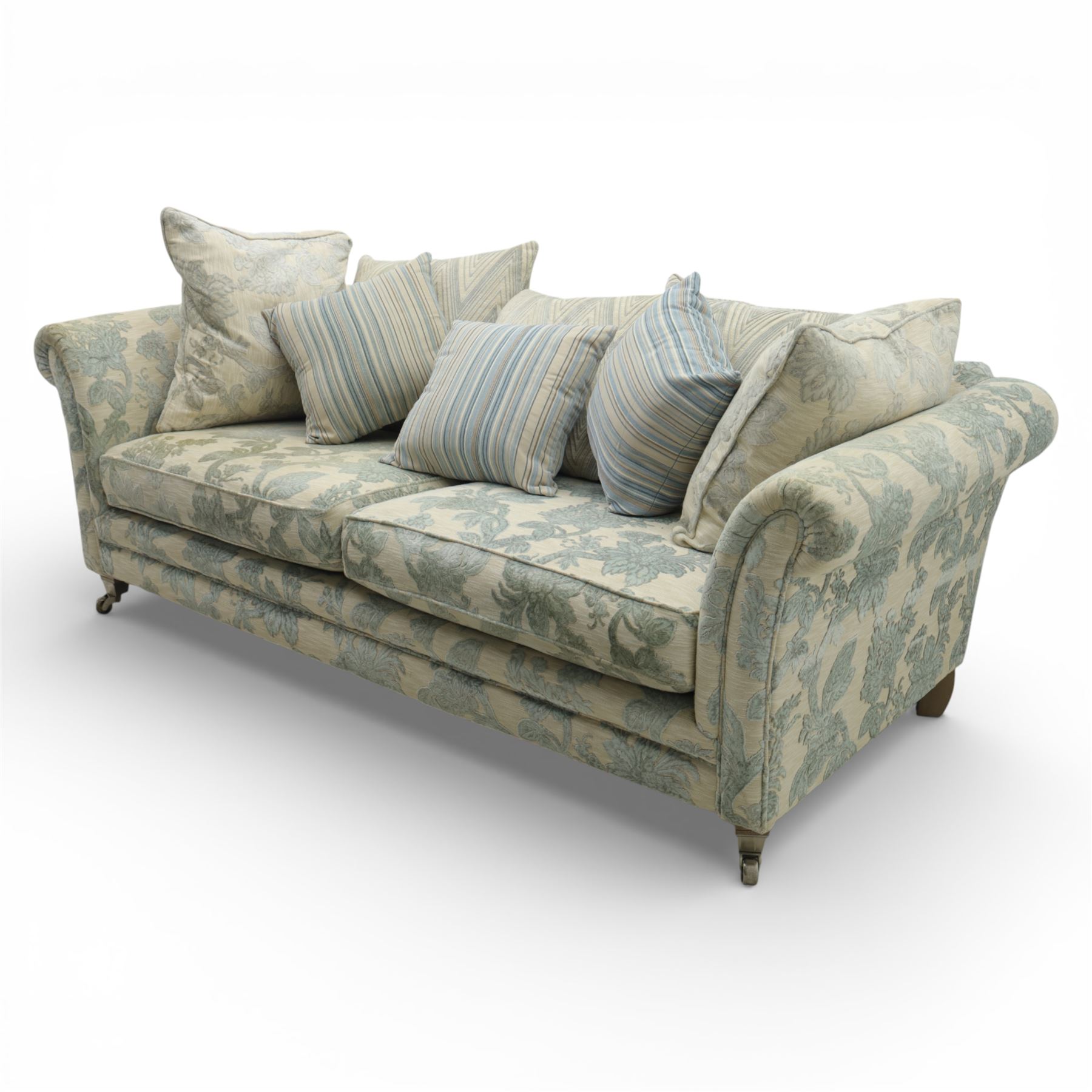 Alstons - 'Lowry' three seater settee, loose cushioned back and seat with additional cushions upholstered in silver and blue floral fabric, supported on square feet with chrome castors to the front