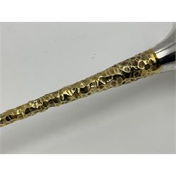 Pair of modern silver candlesticks by Stuart Devlin, the tapering parcel gilt stems with signature textured detailing, each supporting a fluted candle holder and upon a spreading circular foot, hallmarked Stuart Devlin, London 1973, H25cm