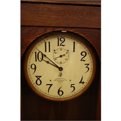  20th century International Time Recording Co. Model 13-7 Electric slave clock, No.10277, circular white Arabic dial with subsidiary seconds, in oak case with glazed door, with pendulum, H161cm, W52cm, D25cm  