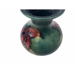 Moorcroft vase, decorated in the Leaf and Berries pattern upon a tonal green ground, together with a further Moorcroft vase, of squat baluster form, decorated in the Iris pattern upon a tonal green ground, each with impressed marks beneath, each H9cm. 