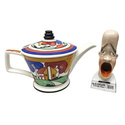 Novelty ashtray modelled as bald headed singer, the base entitled `By the light of the silvery moon...' together with a Sadler teapot of Clarice Cliff Farmhouse pattern style