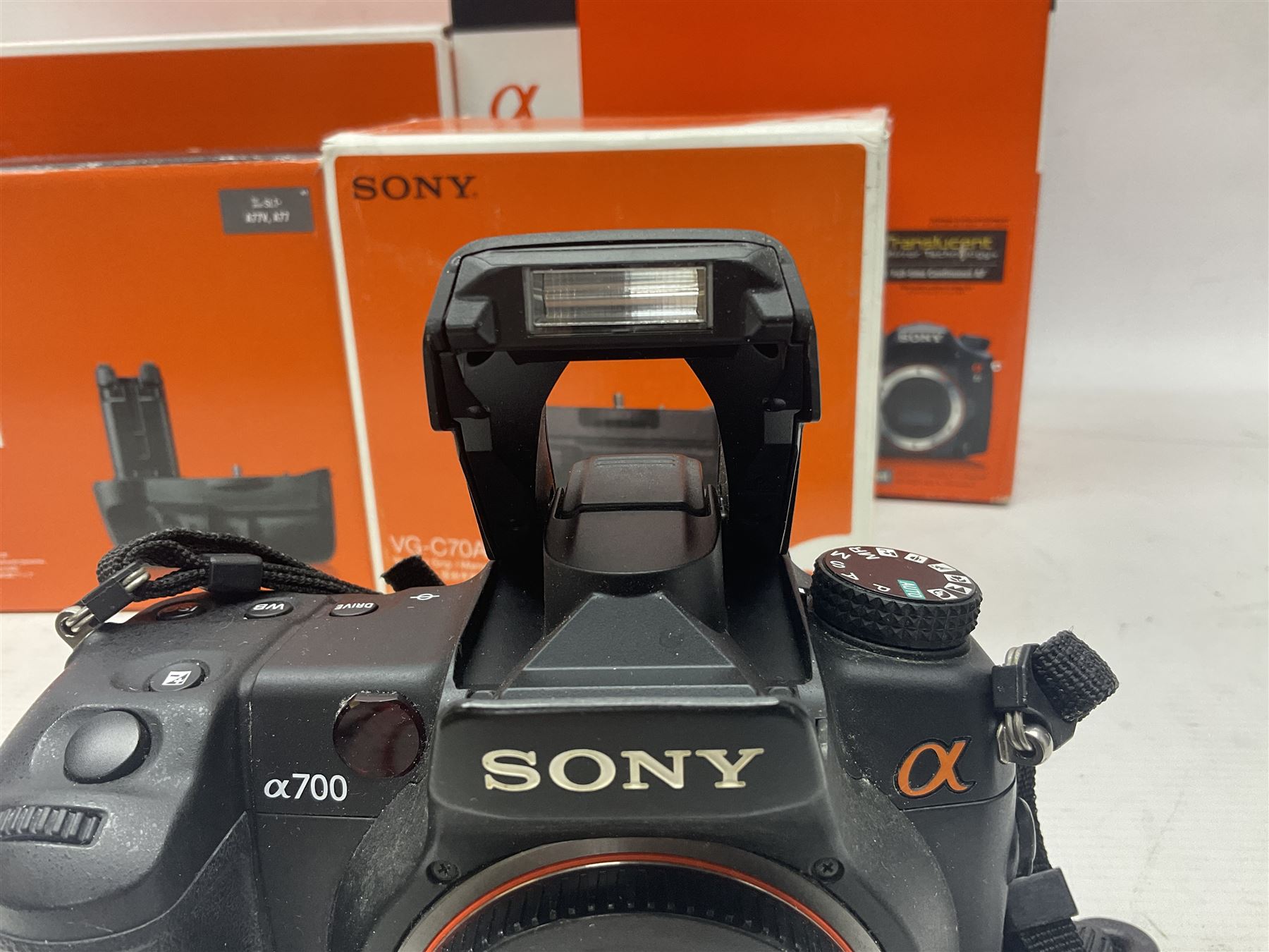 Sony Alpha A700 camera body, serial no 2340937, Sony Alpha A77 camera body, serial no 0715406, together with Sony angle finder and two firm holding grips, all with original boxes  